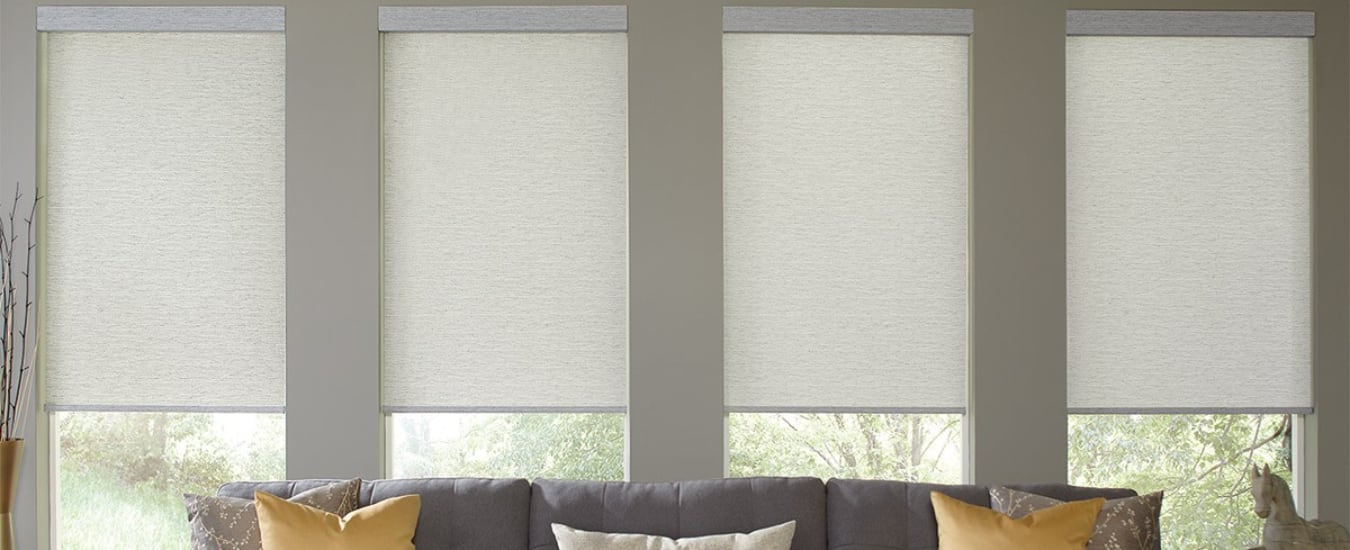 Half-open cellular living room shades behind a couch